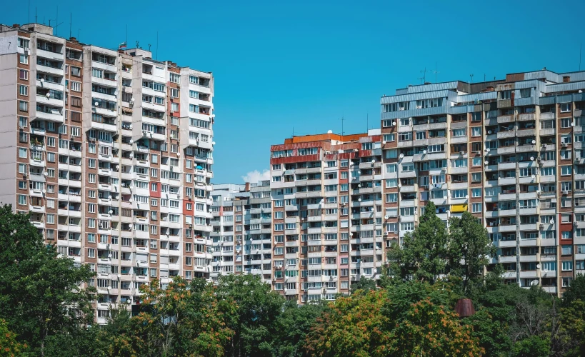 a lot of tall buildings in a forest area