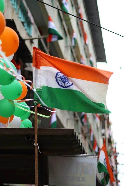 an india and irish flag are flying near balloons