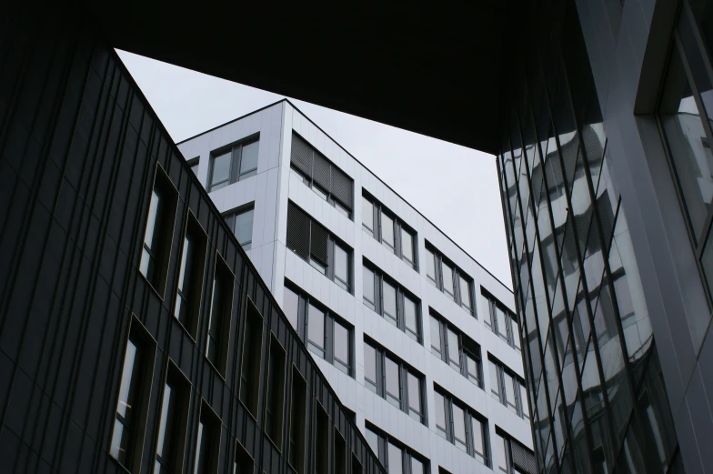 three tall buildings side by side with windows in front of them