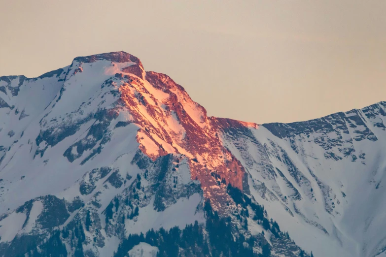 a tall mountain with a large ridge covered in snow