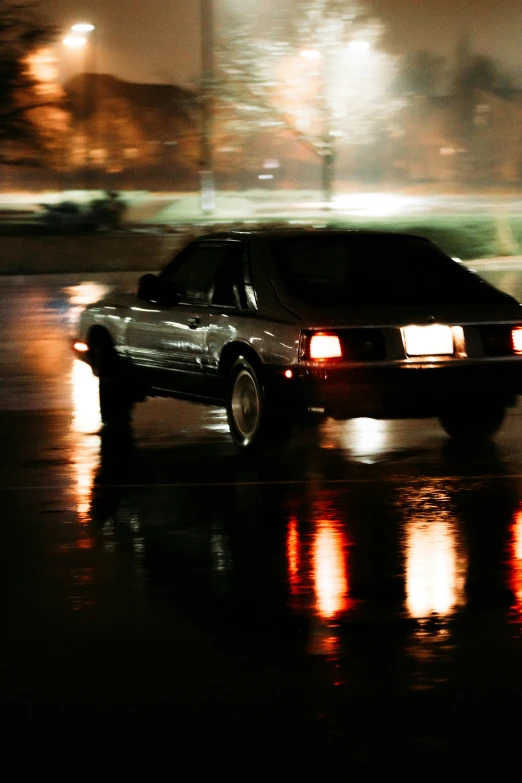 a car parked in the street with headlights on