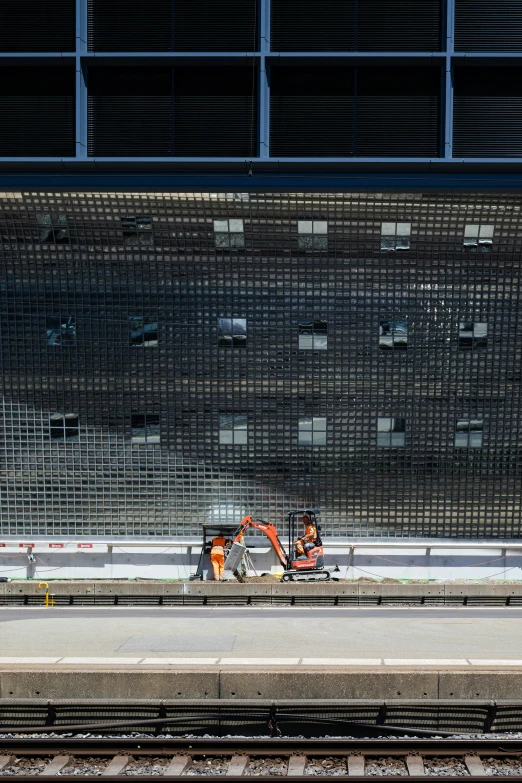 some workers are putting up a mesh fence