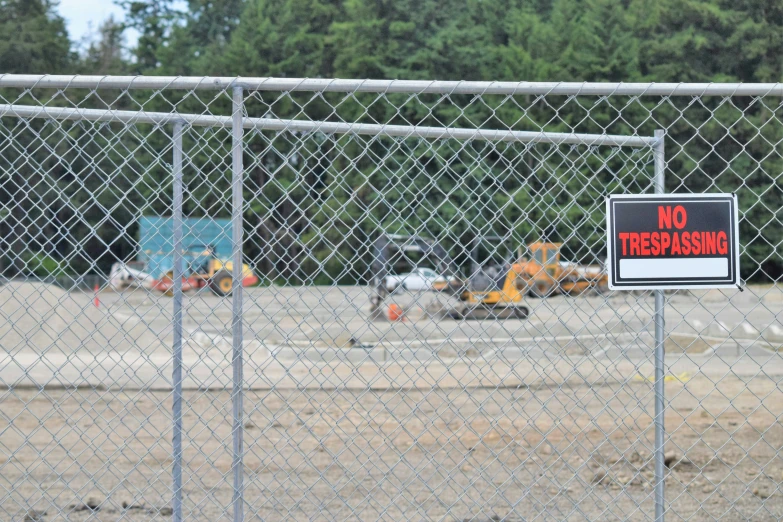 a large piece of equipment sits behind the fence