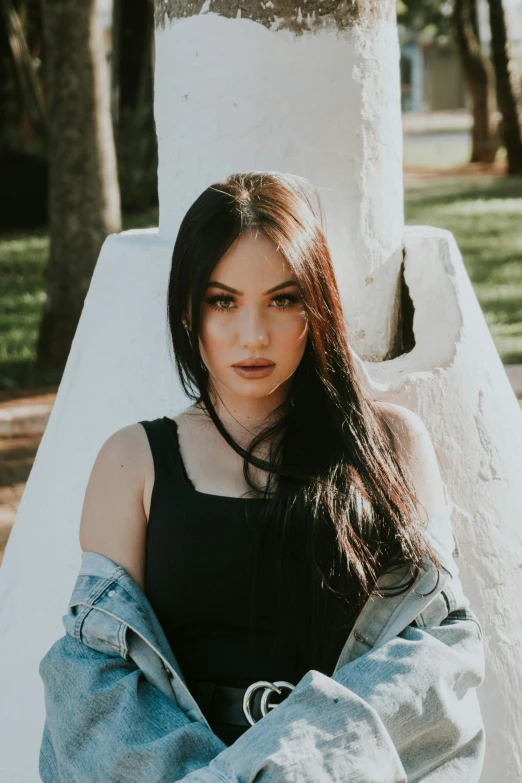 a woman poses for a picture in a park