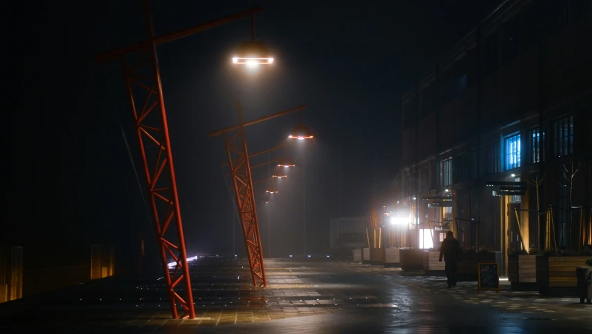 a street light in the middle of a city on a rainy night