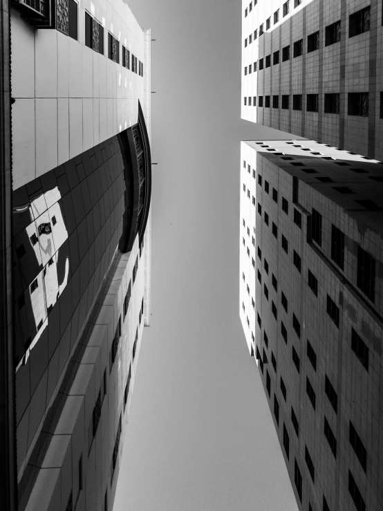 a black and white view looking up at a tall building