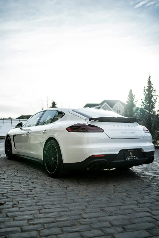 the sports car is parked on the paved area