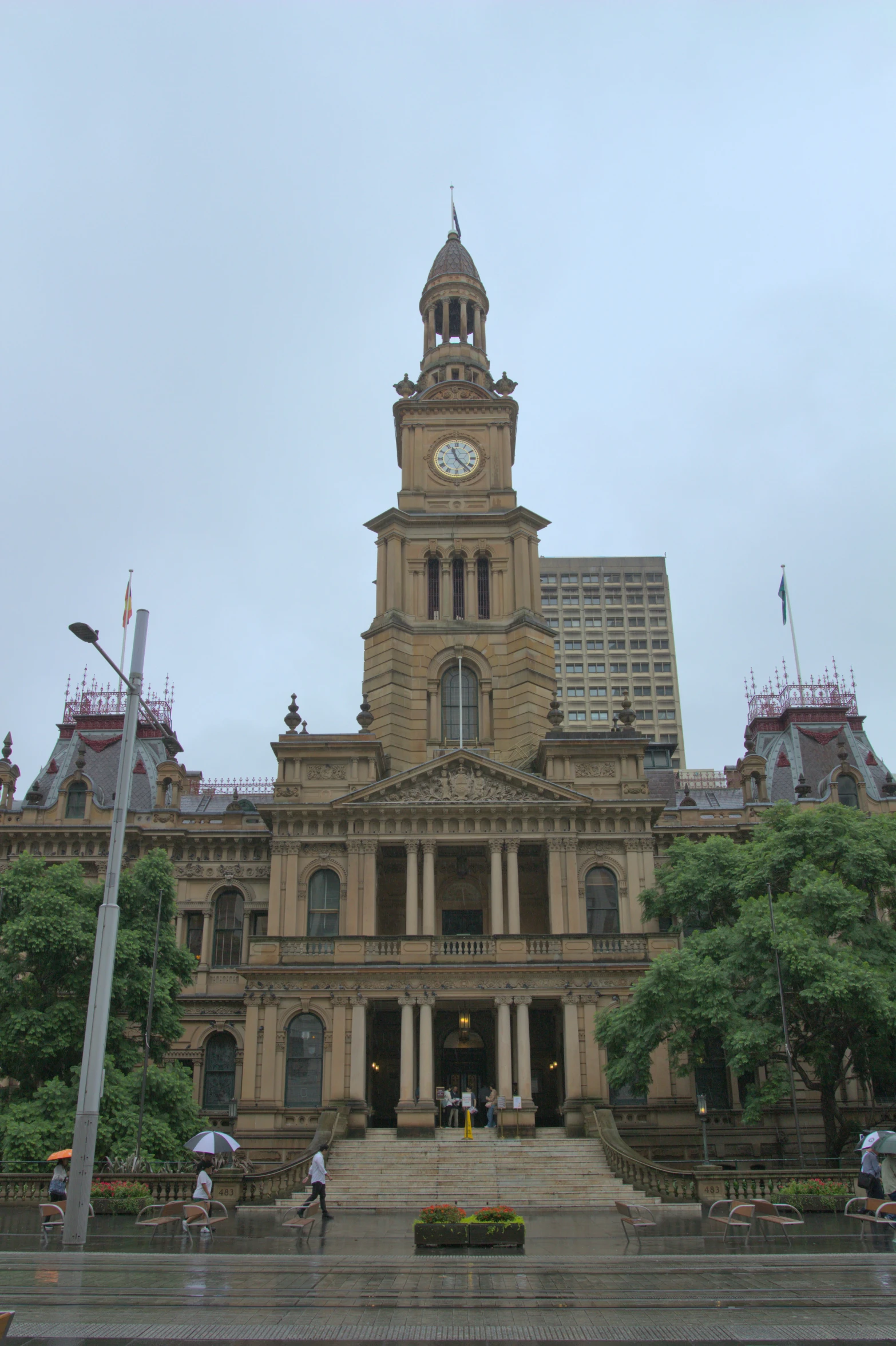 a towered building with people on the outside and in the front