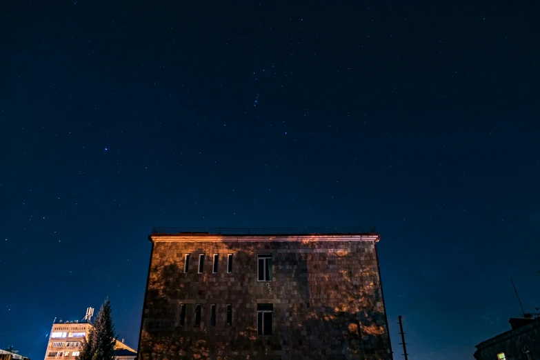 the top of an old building at night with the stars in the sky