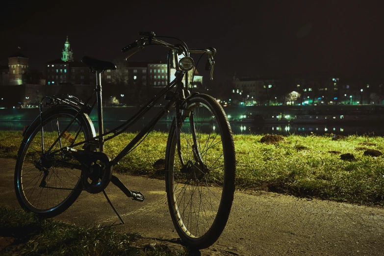 there is a bike parked next to some grass