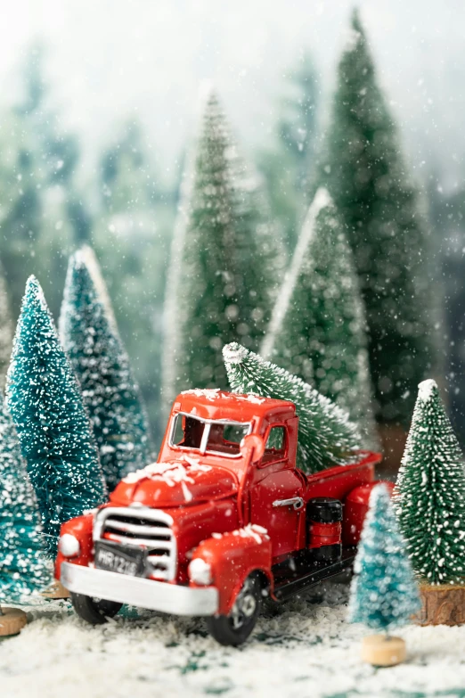 a red truck pulling a trailer with a little christmas tree on the back