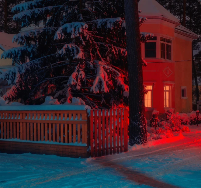 a wooden fence sits outside of a large house