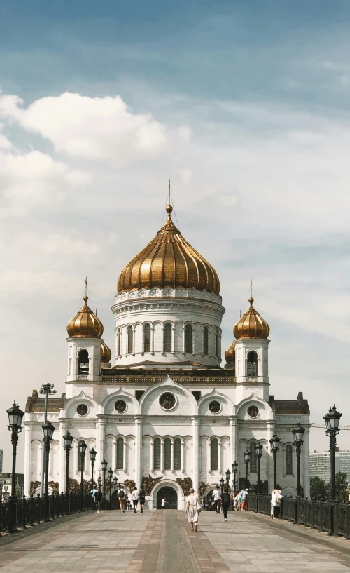 a large white building that has a gold dome