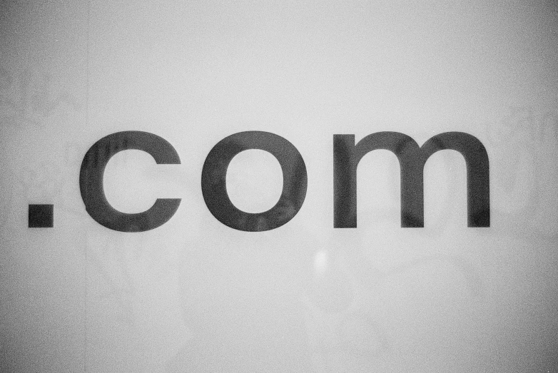 a com logo written on a white background