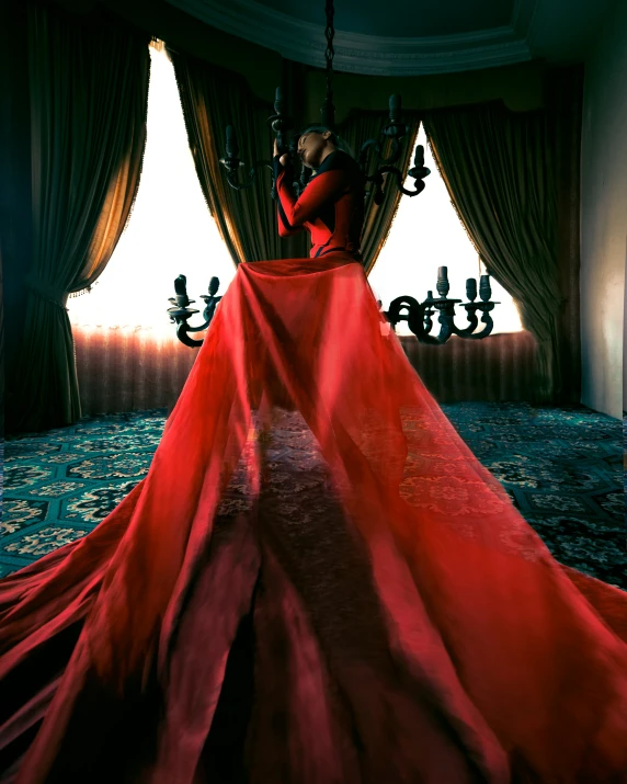 a woman sitting in the middle of a red dress with an ornate design on her body and long sleeves