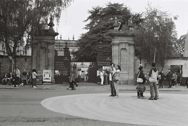 a group of people standing around a garden area