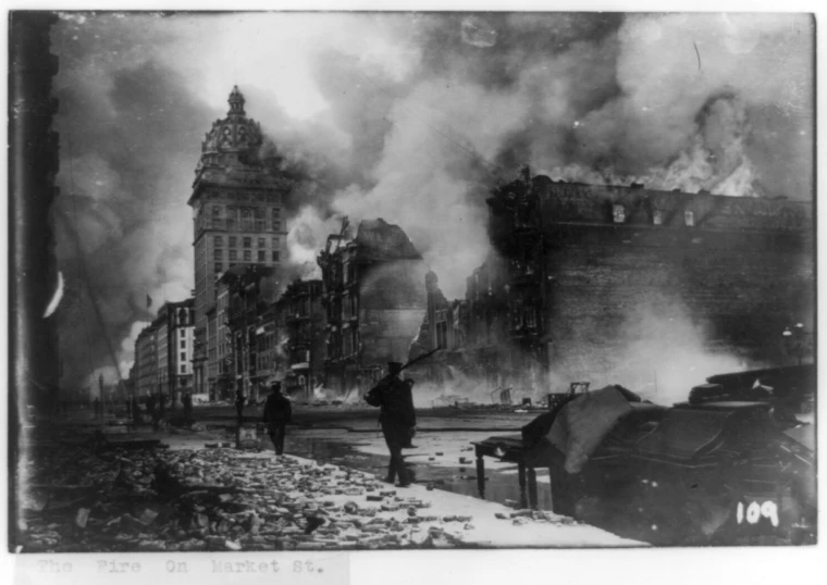 people walking past large, fire - ridden buildings on a city street