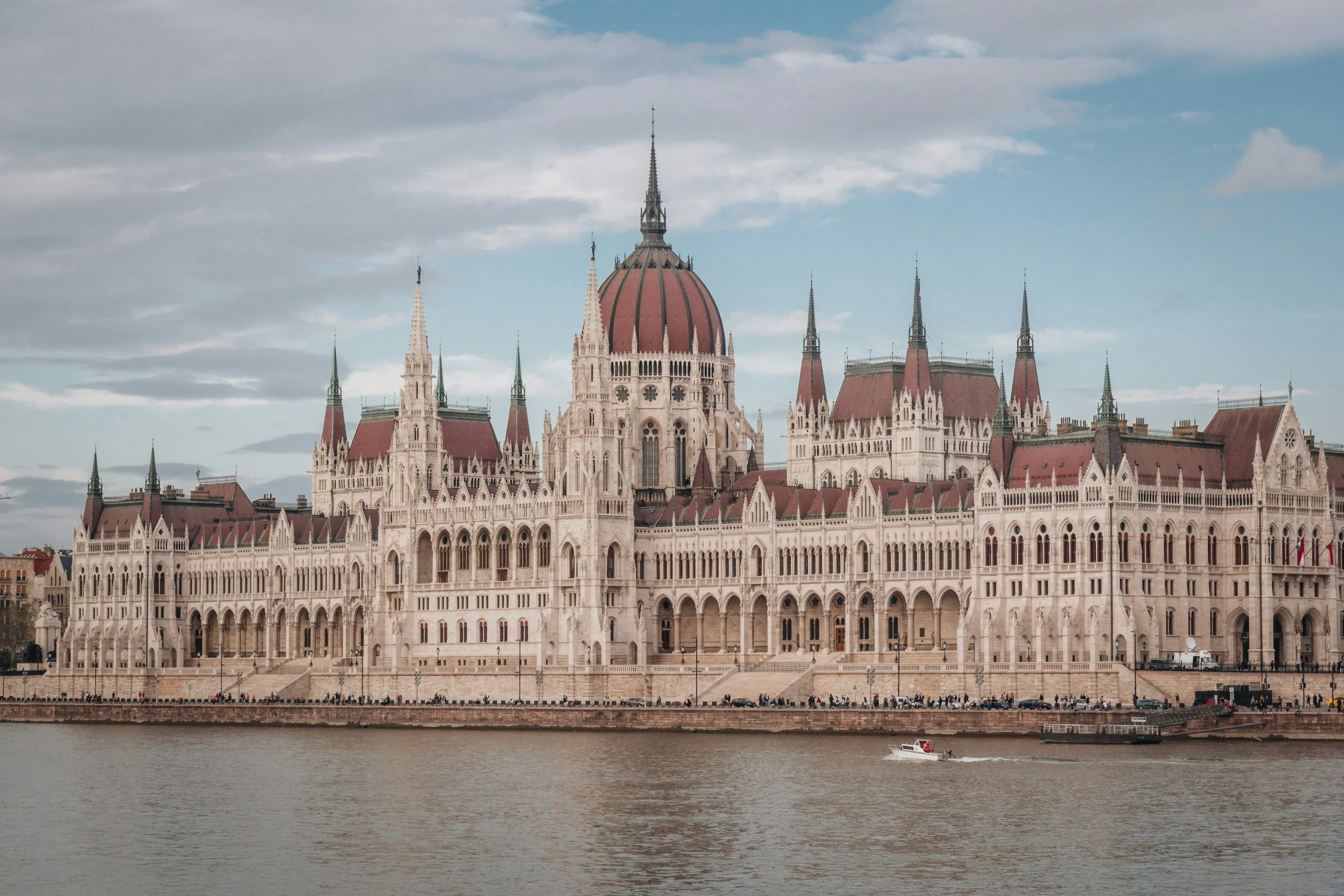 a white and brown castle with a boat on it