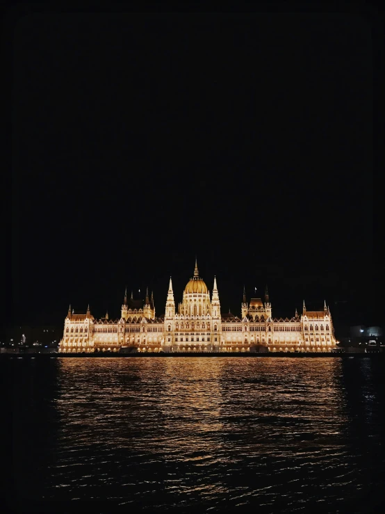 a large castle like building lit up in the night