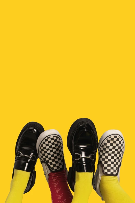 the legs of three people in black and white checkered shoes