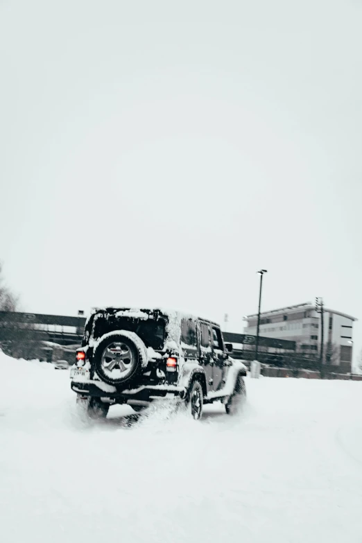 the jeep is making a snow jump in the snowy field