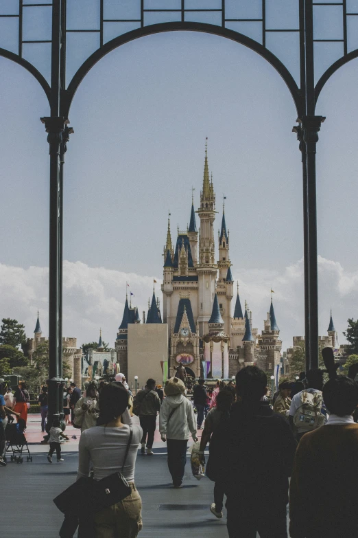 people are in a walkway in front of the castle