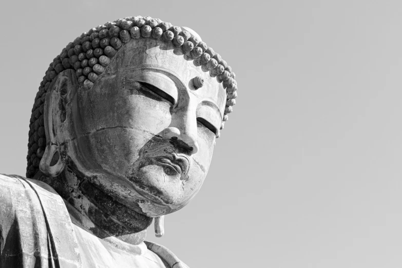 the buddha statue is in a black and white po