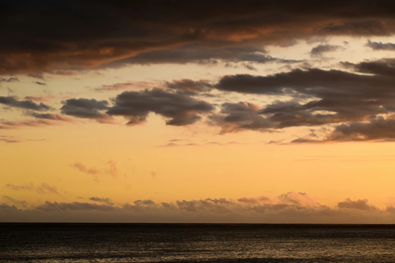 a ship sailing in the water during sunset