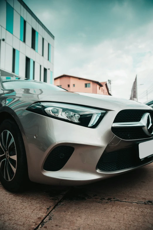 a silver sports car parked next to some tall buildings