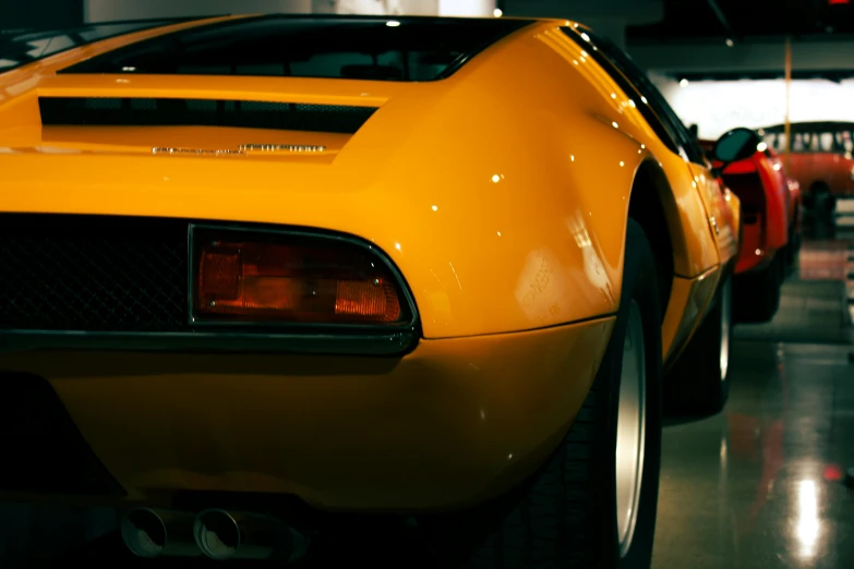 a close - up of an orange sports car on display