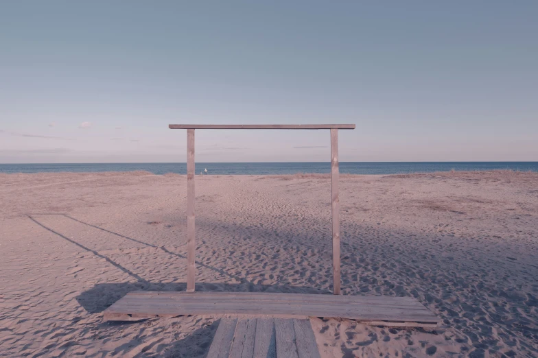 the old broken wooden bench in front of the beach