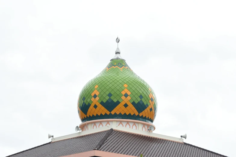 a colorful dome atop a building with a sky background