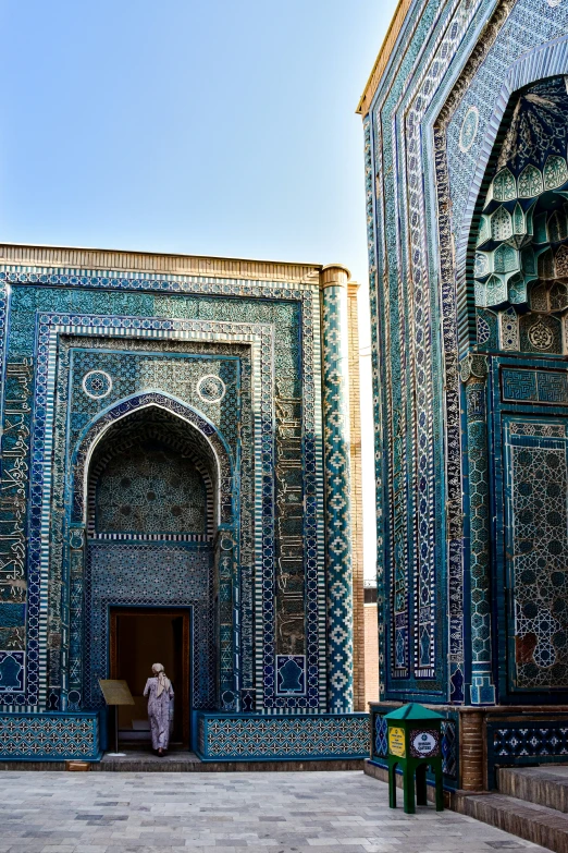 people in the entry to a blue mosaic building