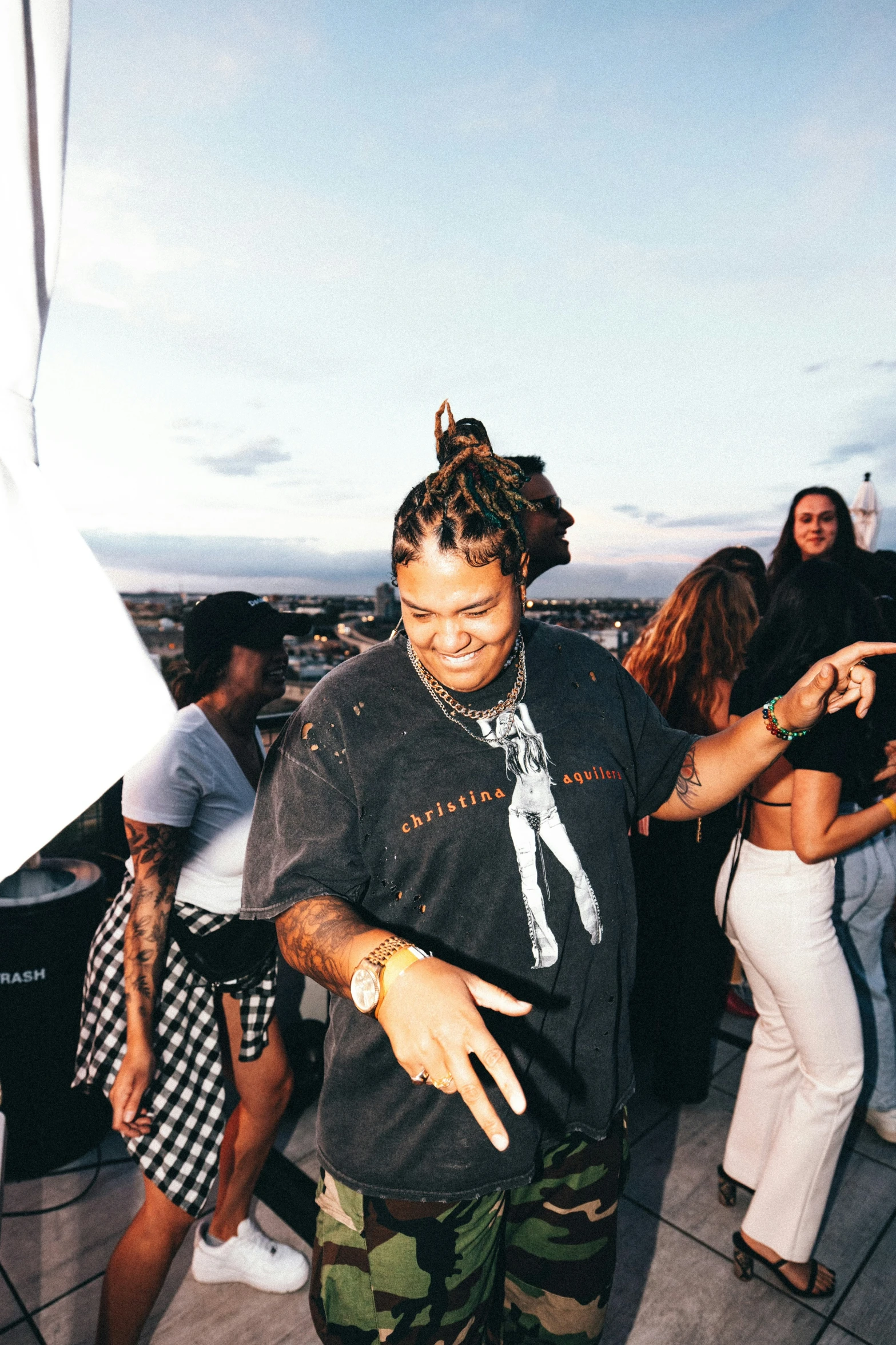 a young person dancing at a party with people around