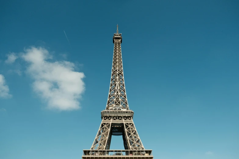 the eiffel tower, paris france, from below, is seen on a sunny day