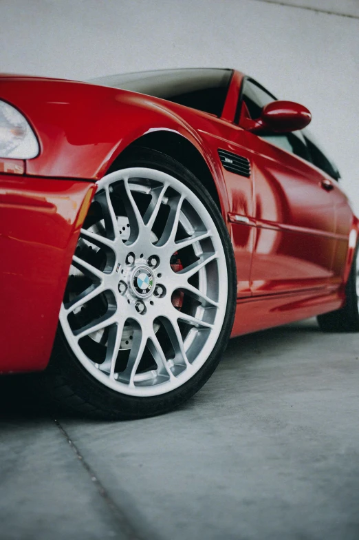 the back end of a red sports car parked