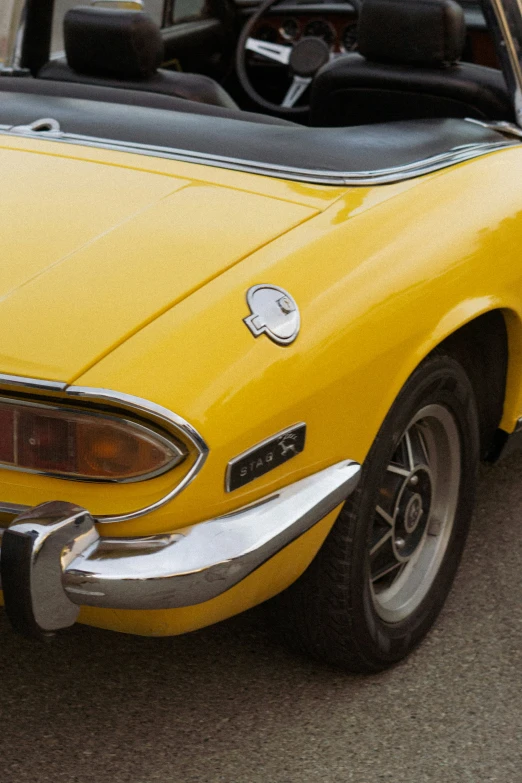 a yellow sports car parked on the road