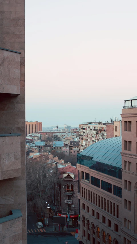 a view from a building in a city with tall buildings