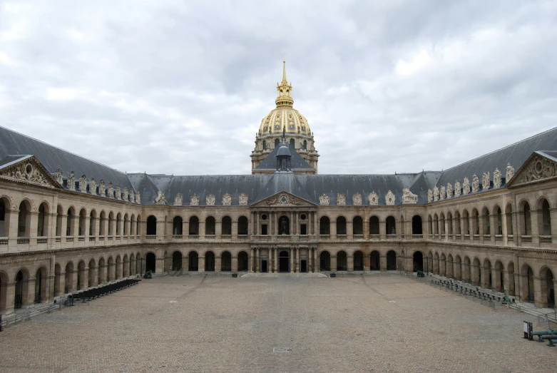 the courtyard of a large building with an arched archway