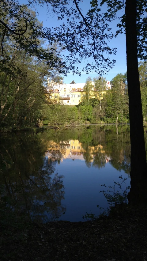 the water is reflecting the building behind it