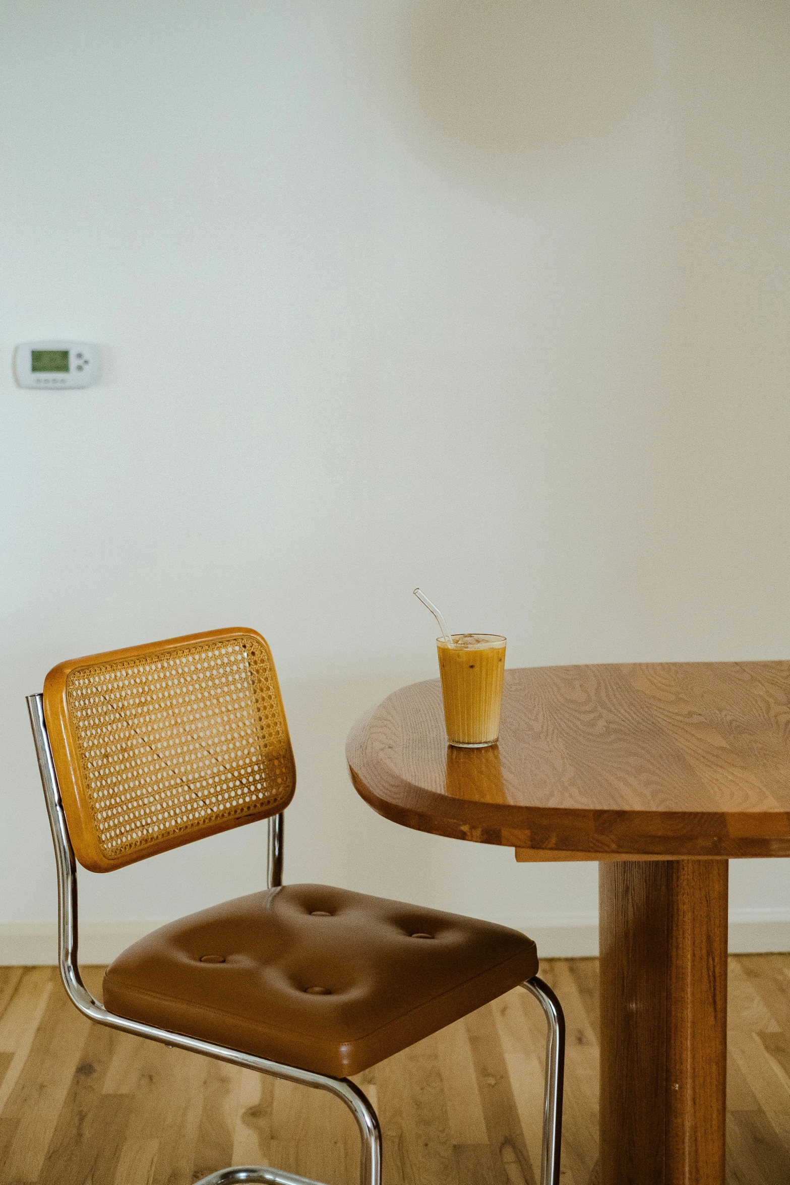 a table with two chairs and a yellow cup on it