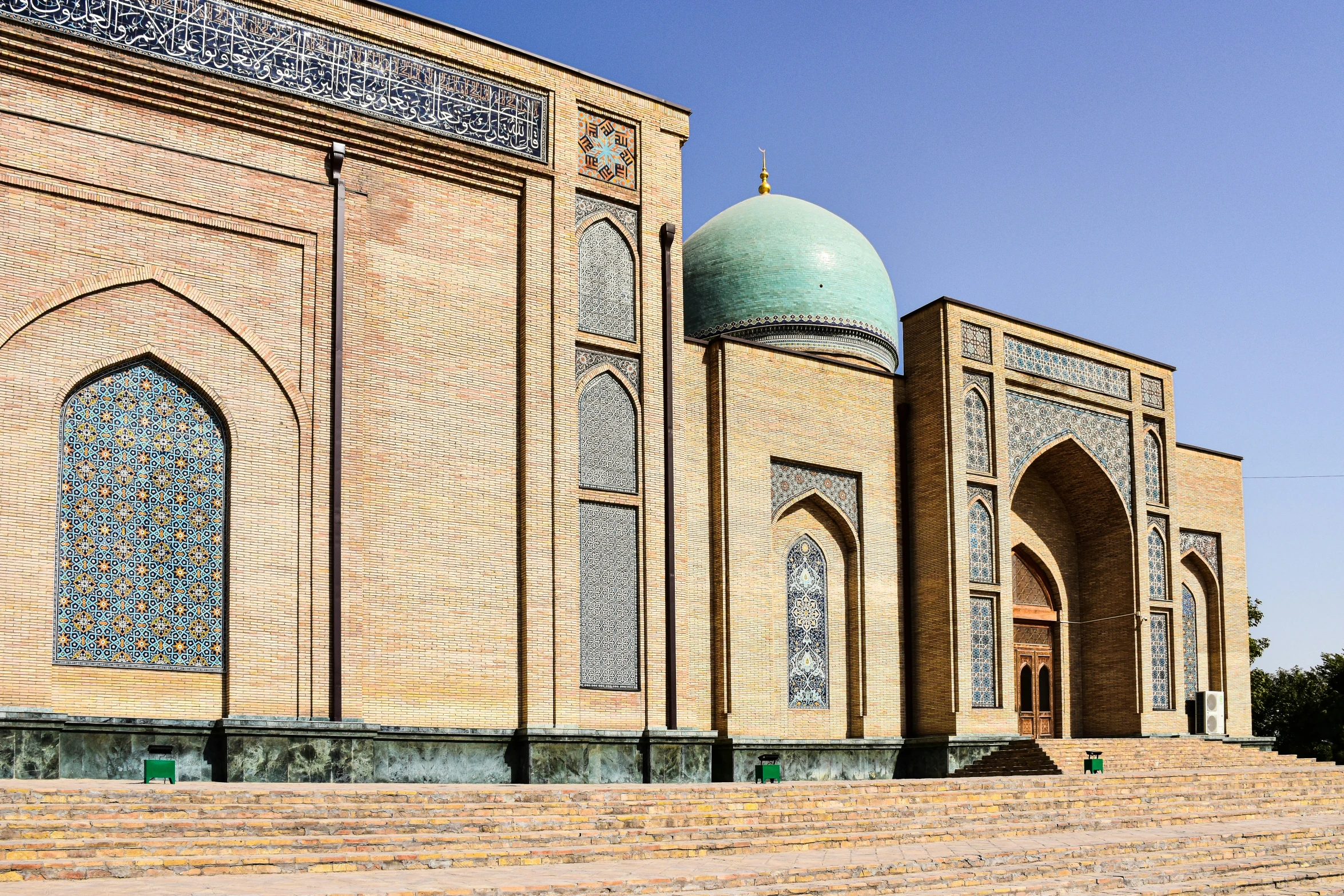 a large building with blue domes and a blue sky