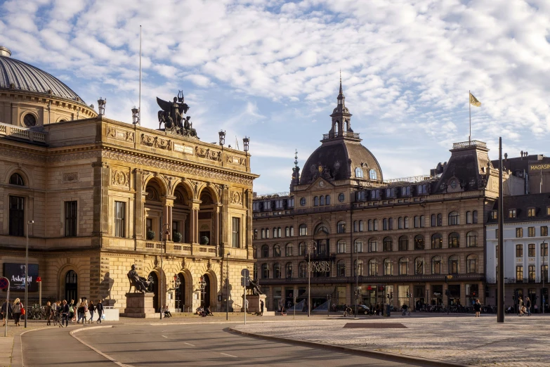 the buildings of a town square with a sky background