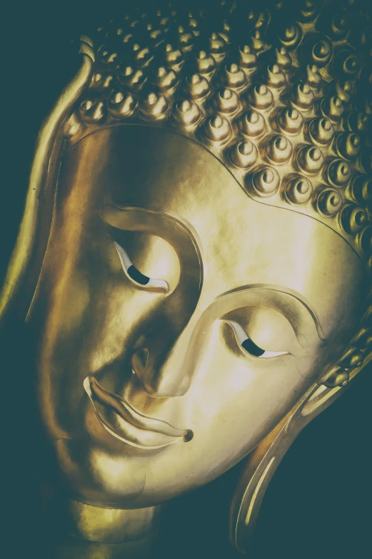 the front of an antique golden buddha statue