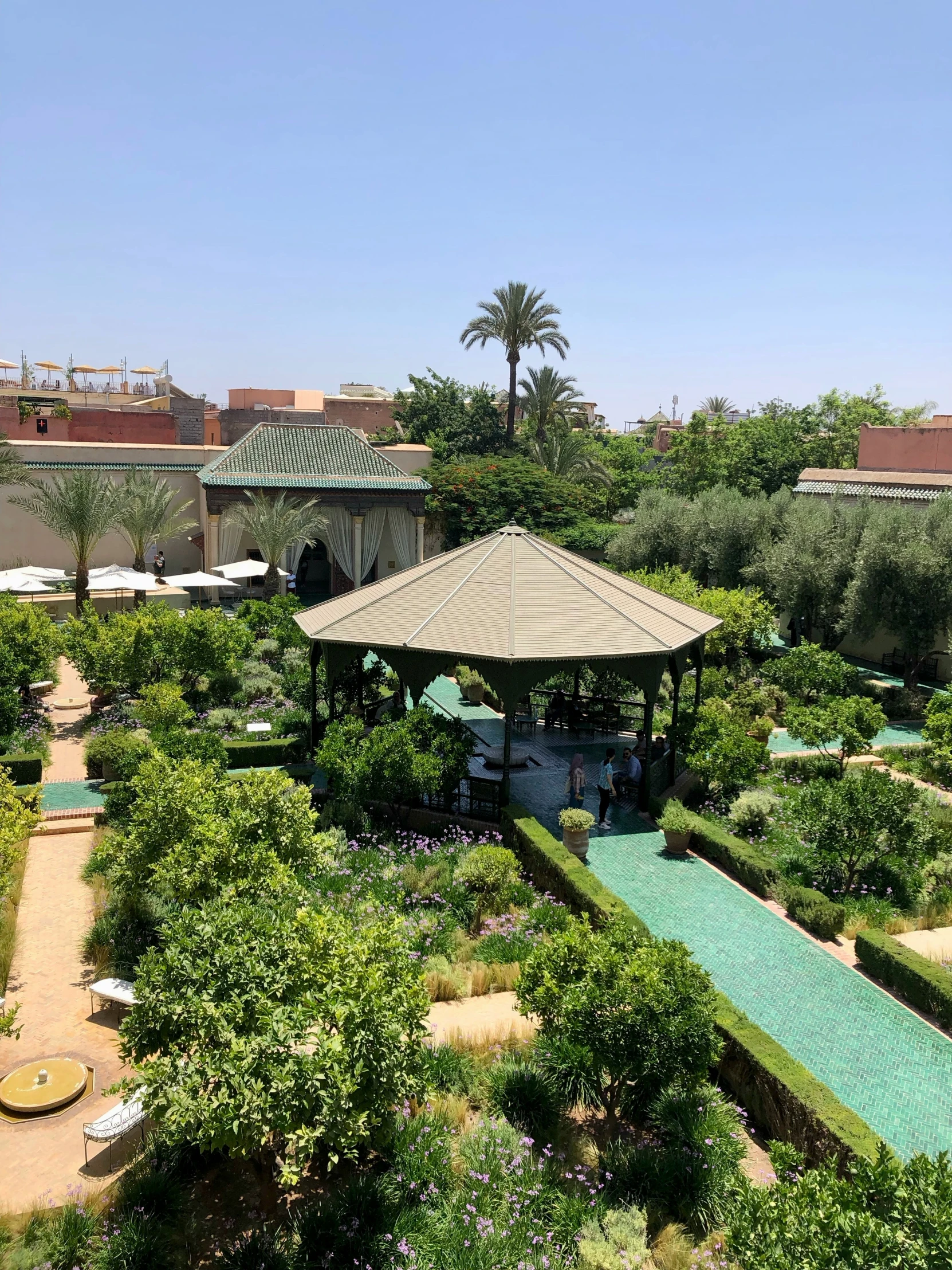 an aerial view of a small park with various trees and shrubs