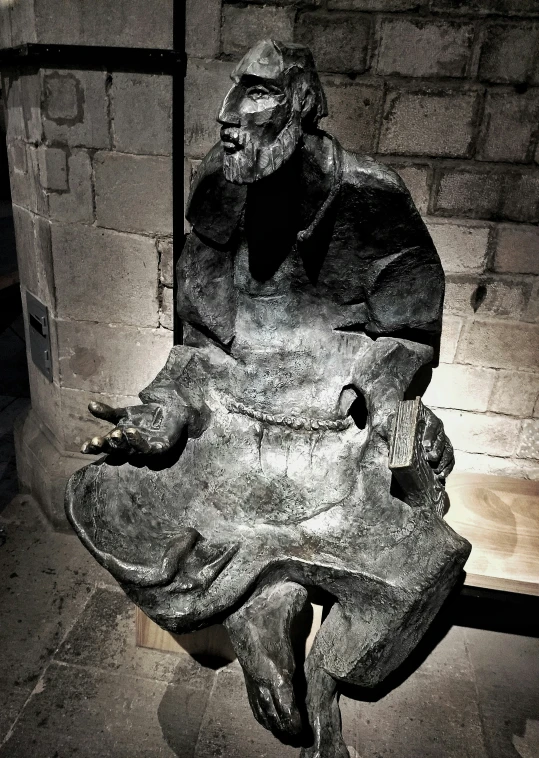 a stone carving in front of a brick wall