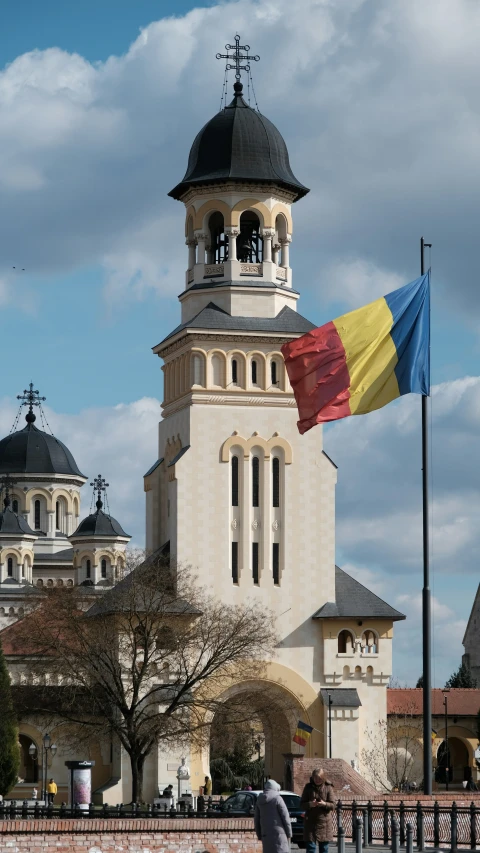 people walking by a building and flag