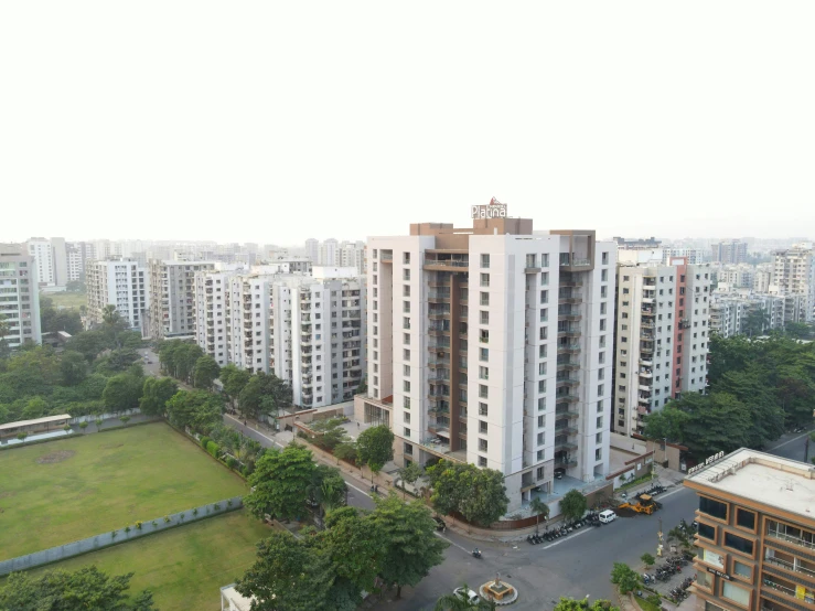 several tall buildings with a lawn in front