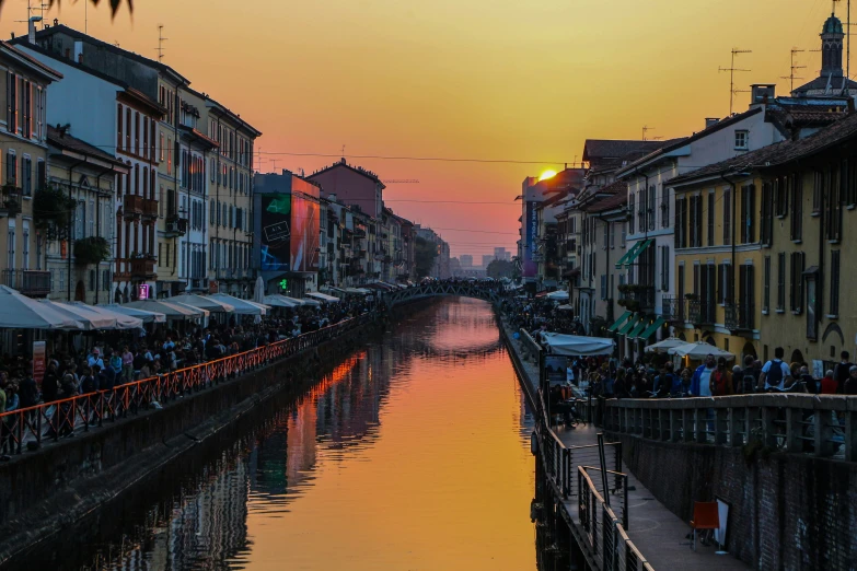 people on boats docked near a street and a body of water