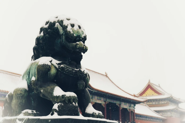 a lion statue standing in front of an oriental building